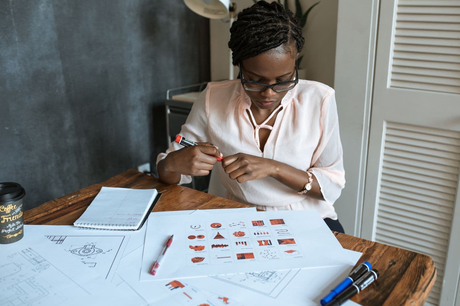 Designer sketching icons on paper